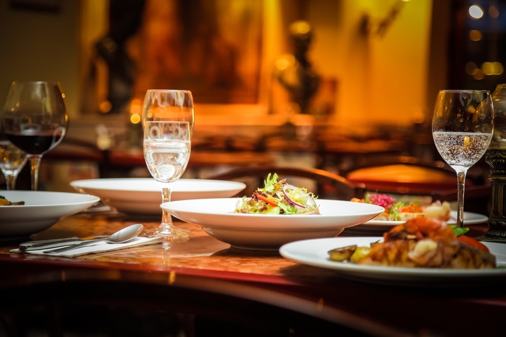 Plated food and glasses at one of the most romantic Durango restaurants