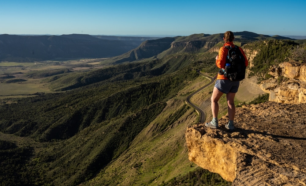 Best Time to Visit Mesa Verde National Park 4 A hiker enjoying an overlook at Mesa Verde National Park near Durango