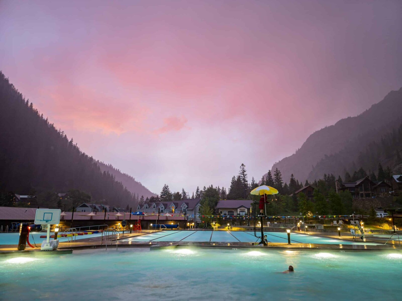 The Best Colorado Mountain Towns to Visit This Year 1 Sunset view of Ouray Hot Springs. The geothermal pools are the best things about many Colorado Mountain towns.